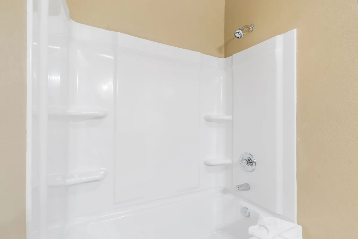 A contemporary bathroom with a bathtub and modern shower fixtures. The soothing wall color and clean design create a spa-like atmosphere, ideal for unwinding after a long day of adventure.